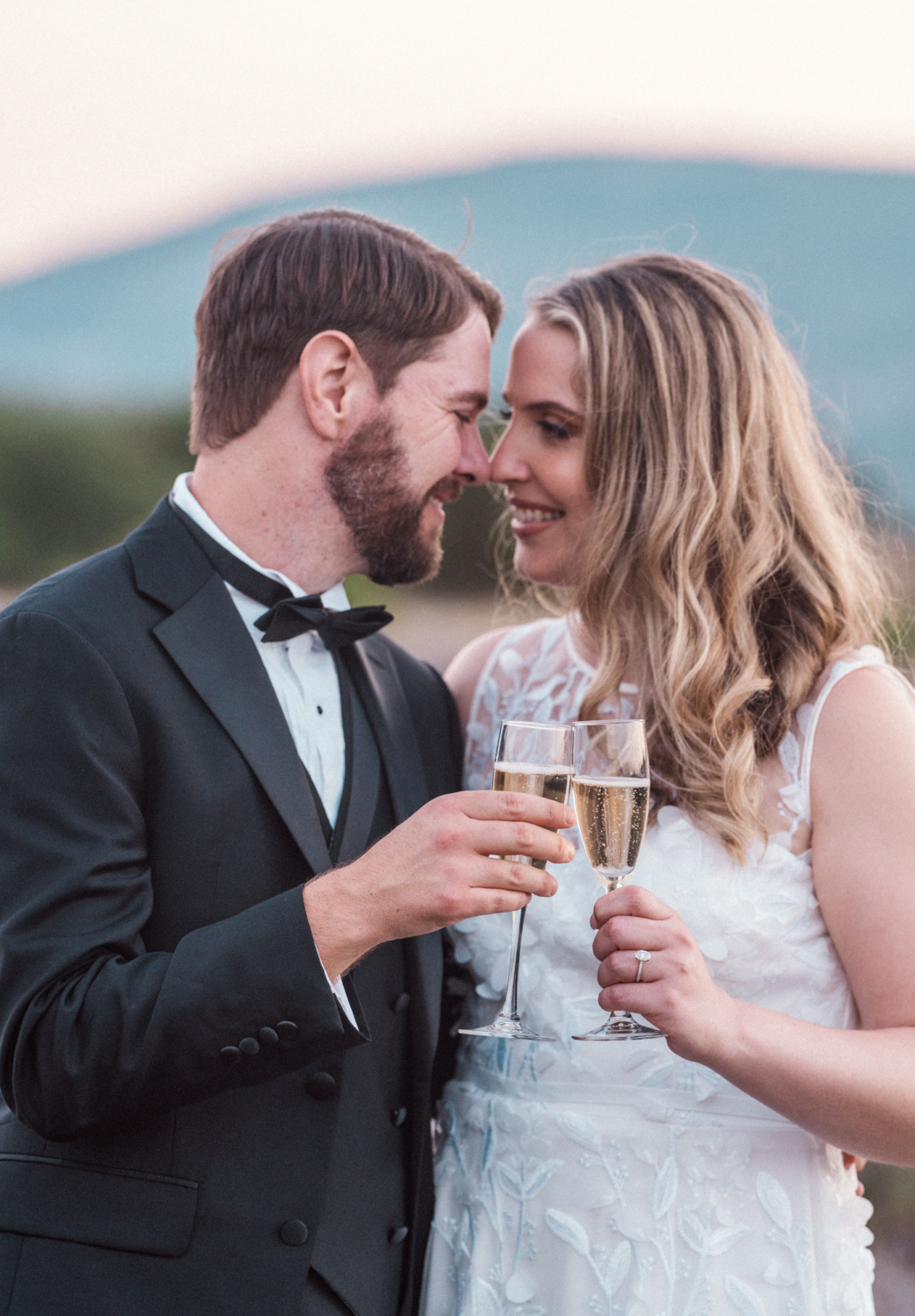 newlywed couple toasting each other with champagne