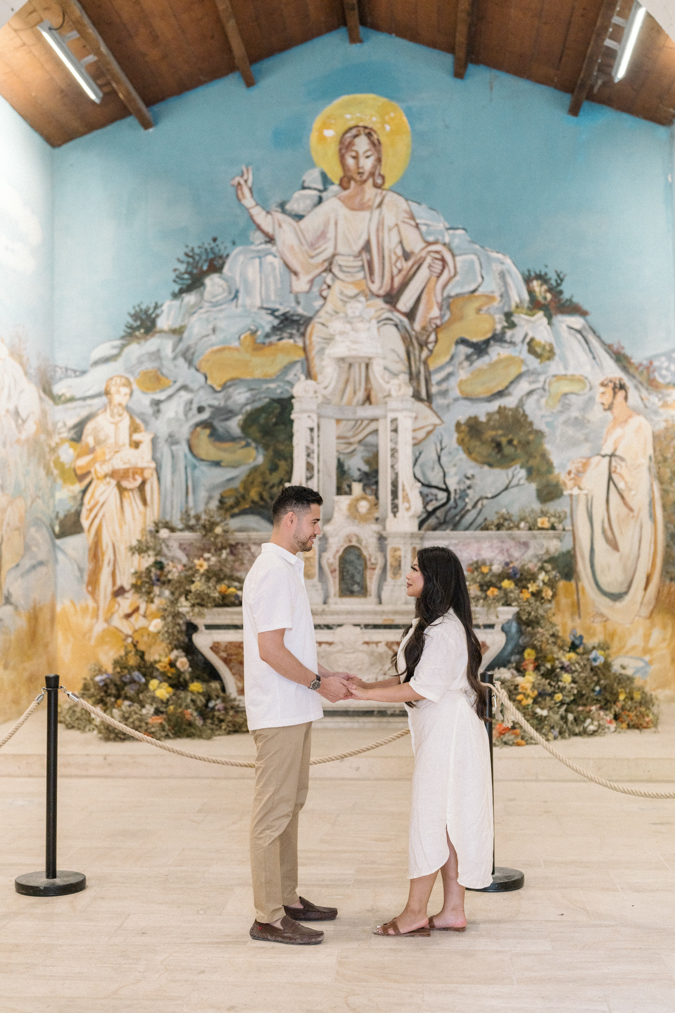 engaged couple hold hands in chapel in les baux de provence during Engagement Photos In Provence