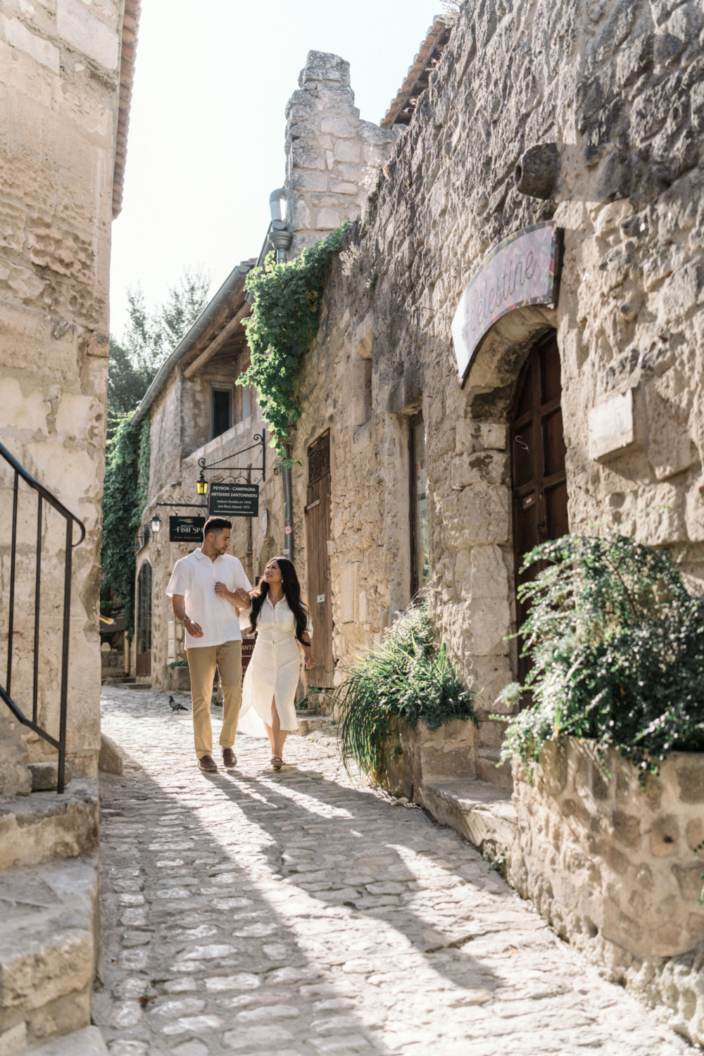 newly engaged couple walk in les baux de provence