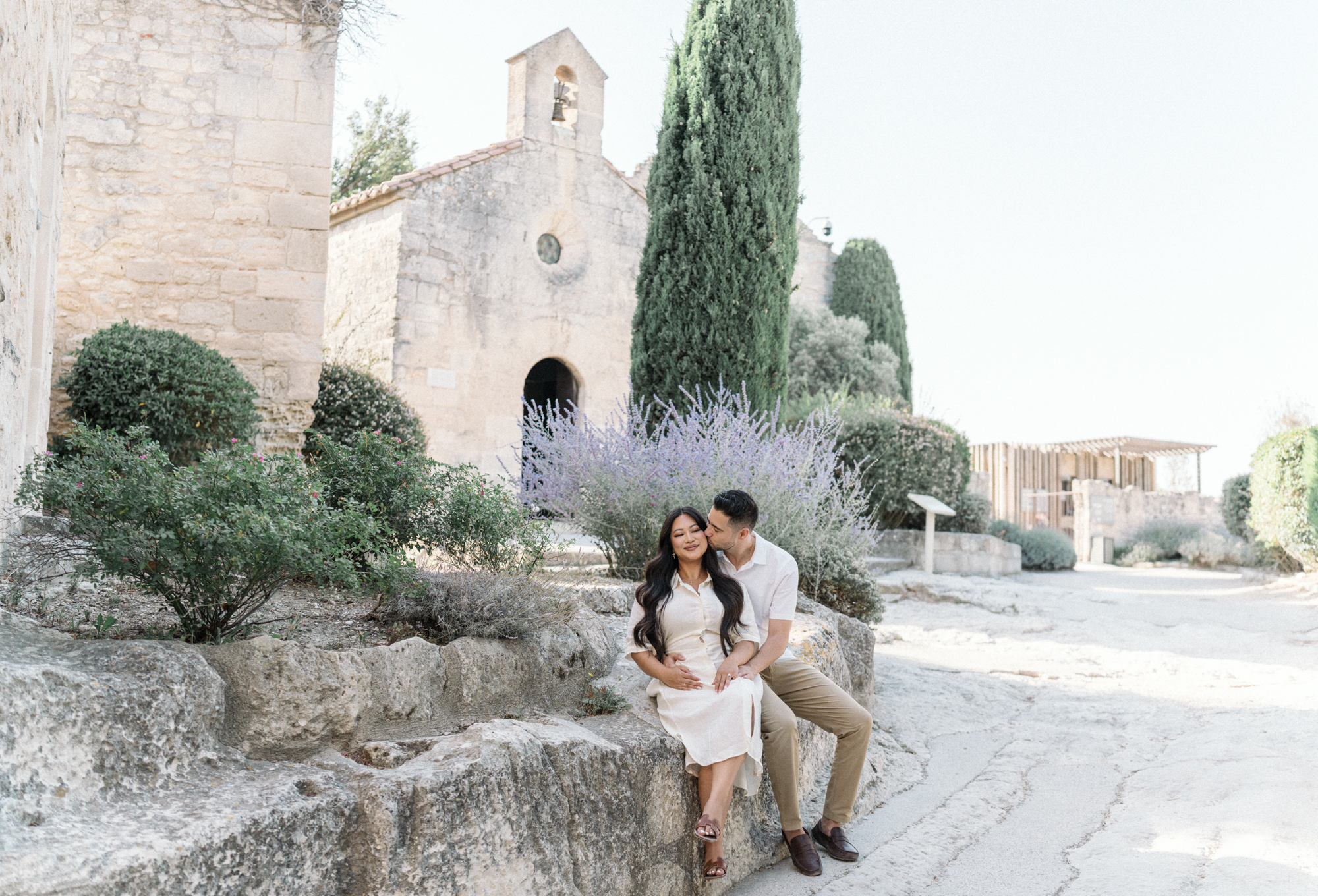 man kisses woman's cheek in les baux de provence