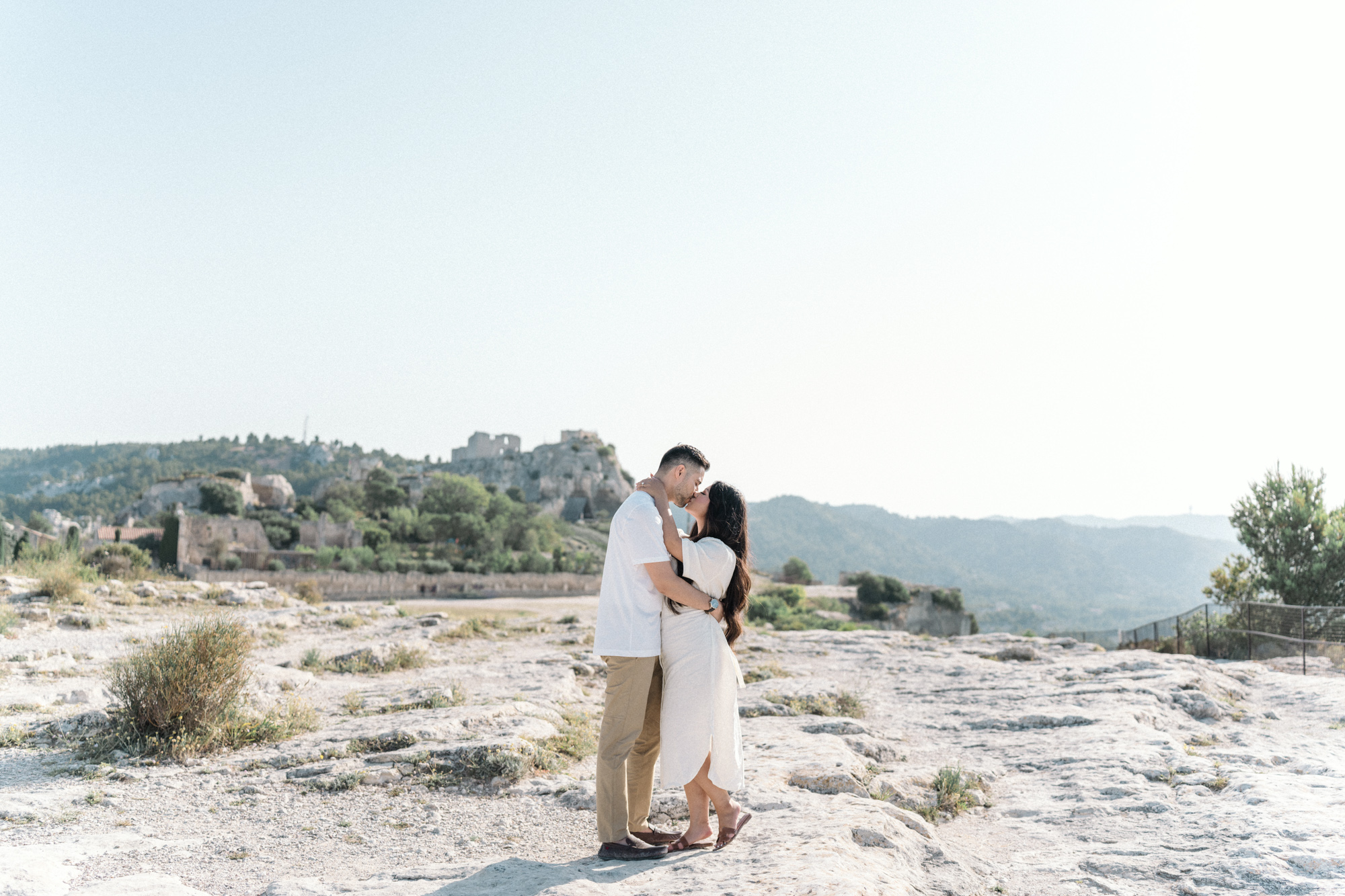 newly engaged couple kiss in les baux de provence