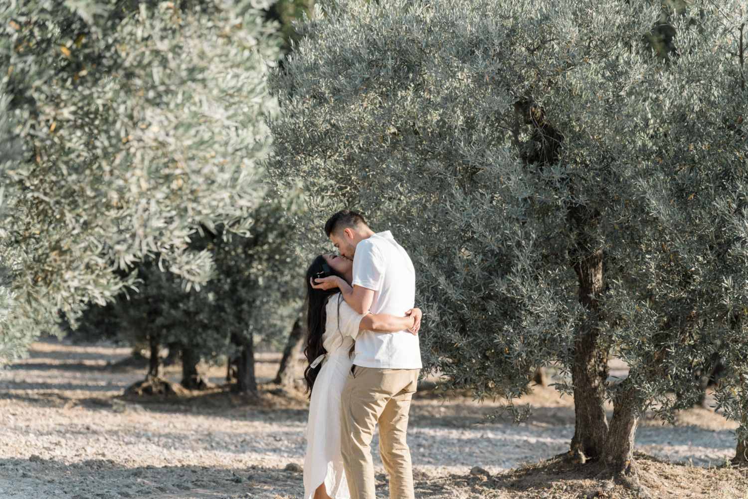man proposes to woman in olive grove