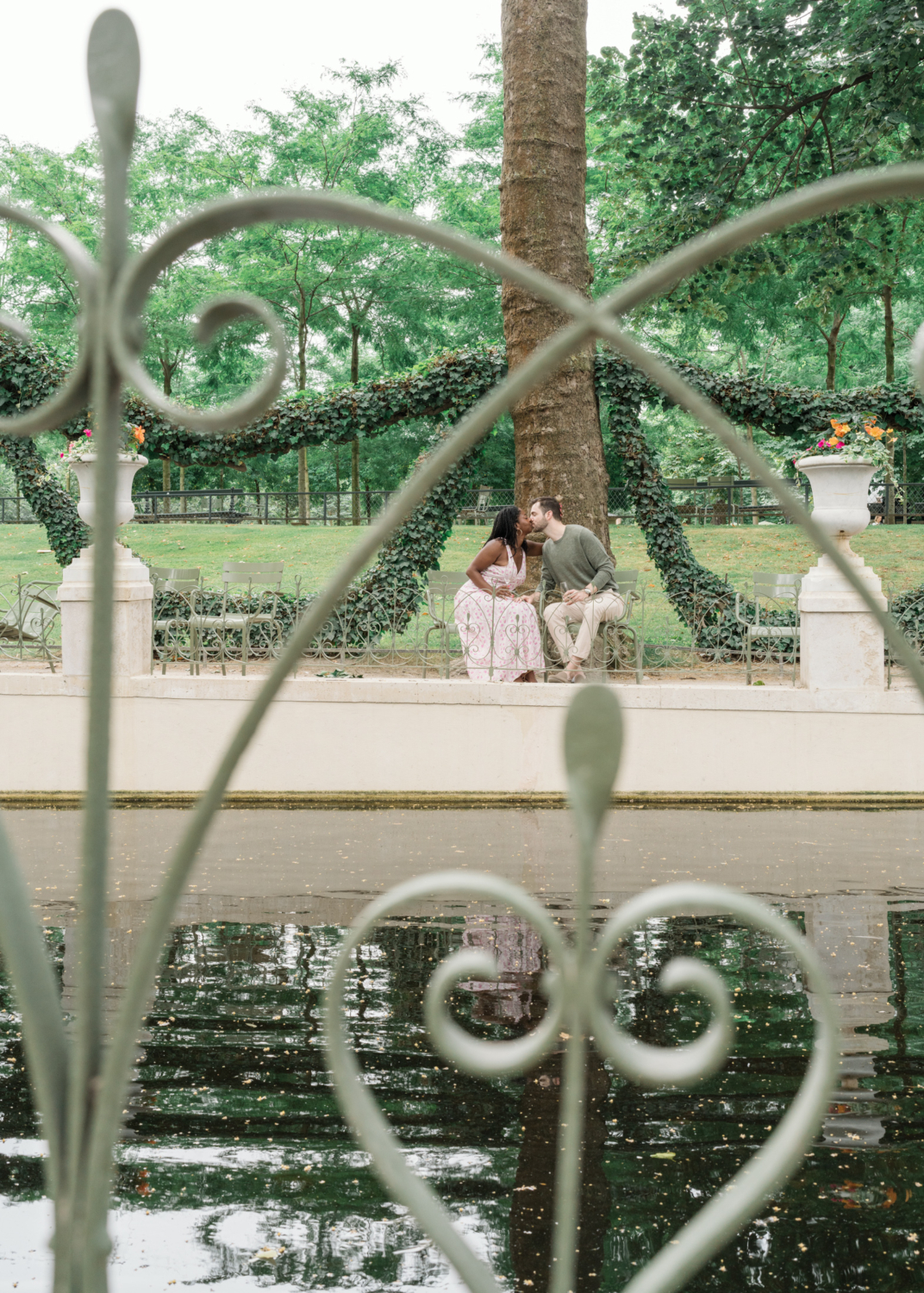 newly engaged couple kiss in luxembourg gardens paris