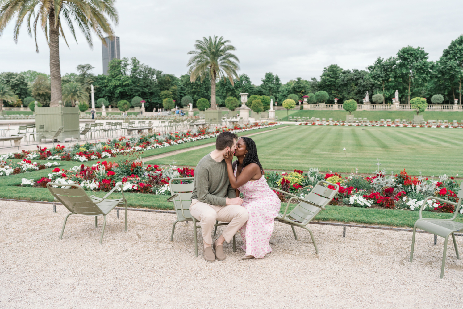 newly engaged couple kiss in luxembourg gardens paris