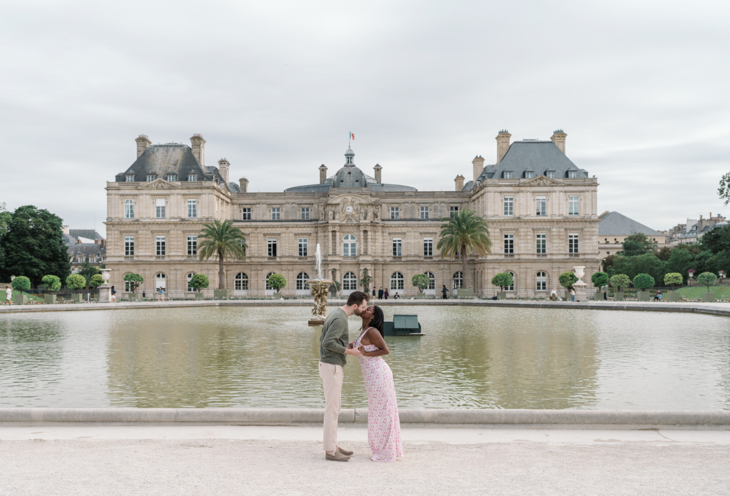 newly engaged couple kiss in luxembourg gardens paris