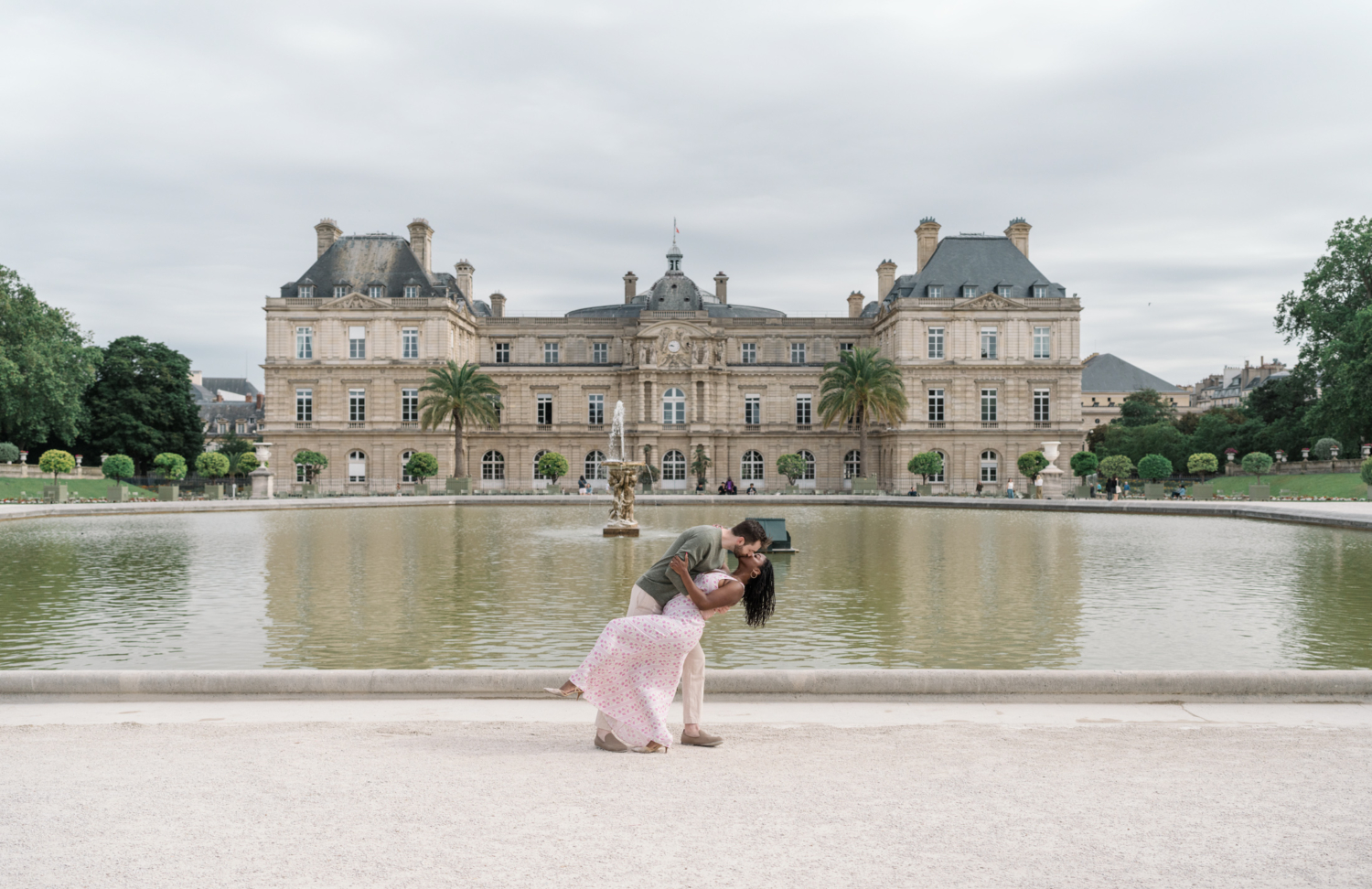 newly engaged couple kiss and dip in luxembourg gardens paris