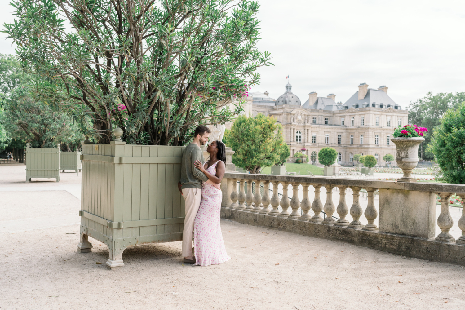 newly engaged couple embrace in luxembourg gardens paris