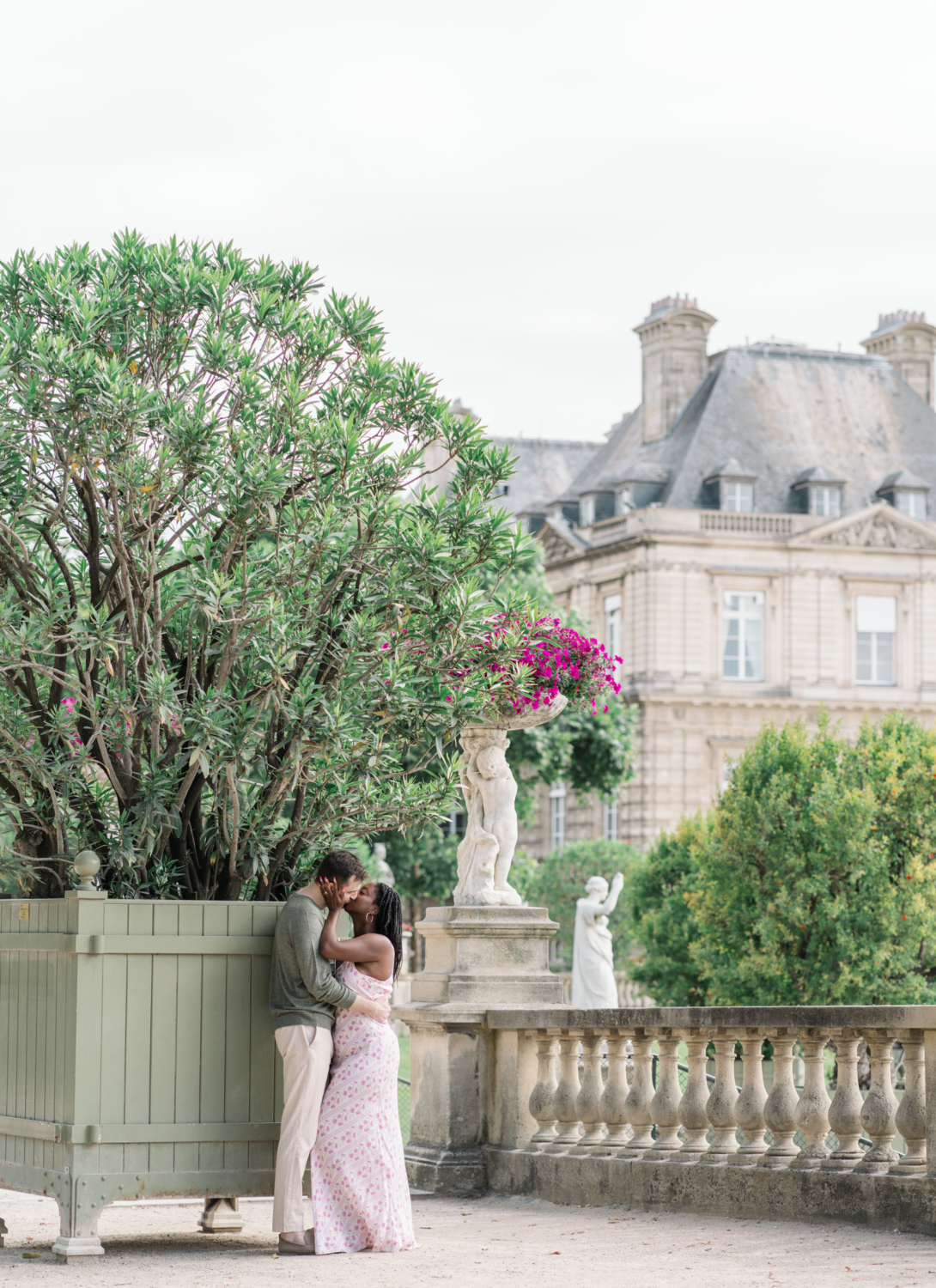 newly engaged couple kiss in luxembourg gardens paris