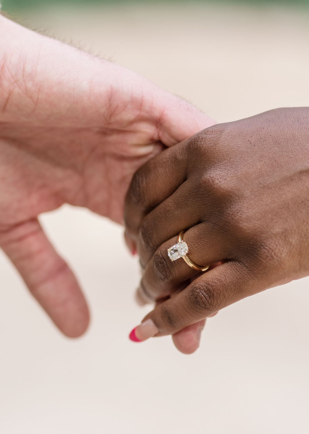 diamond engagement ring and two hands