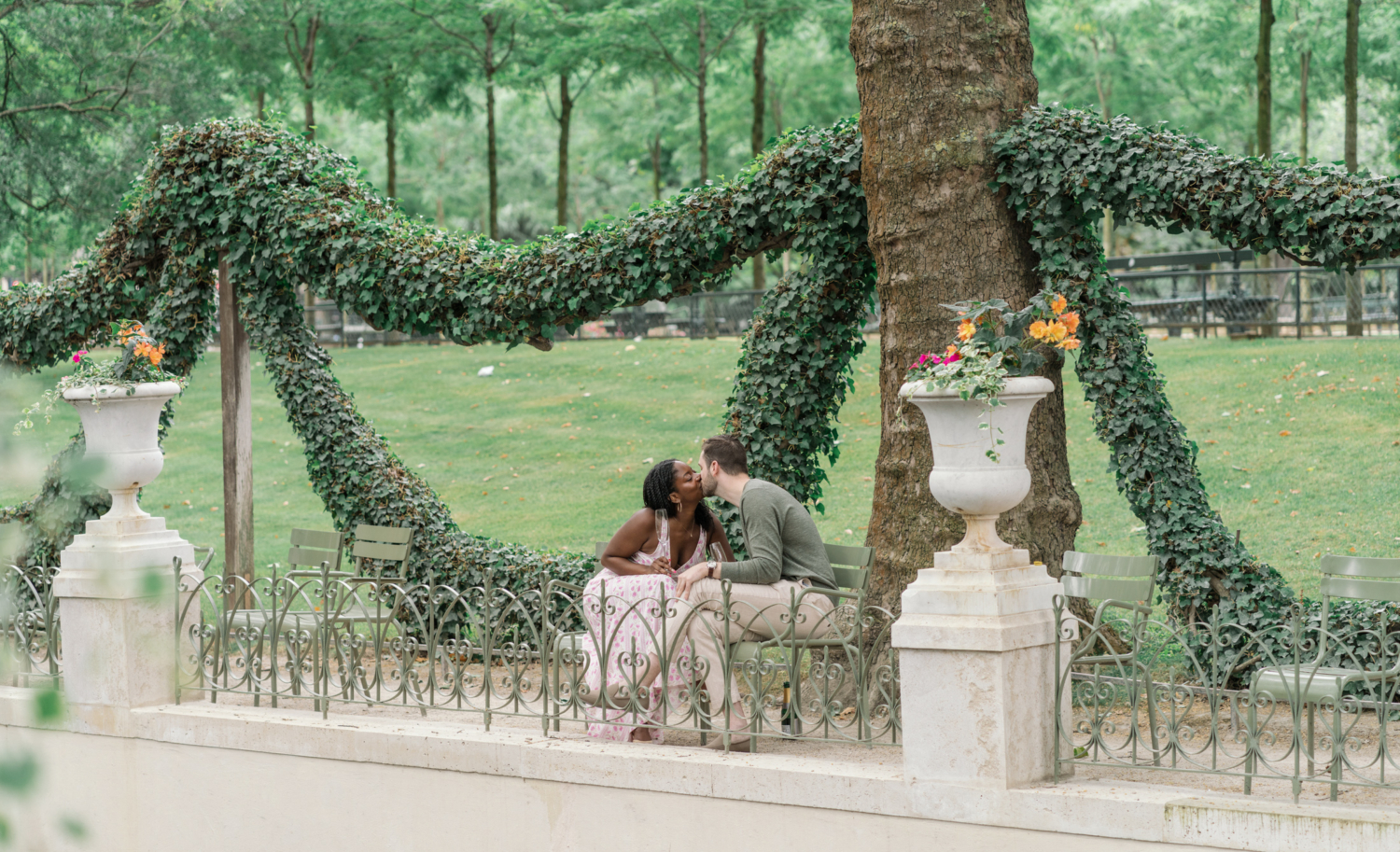 newly engaged couple kiss in luxembourg gardens paris