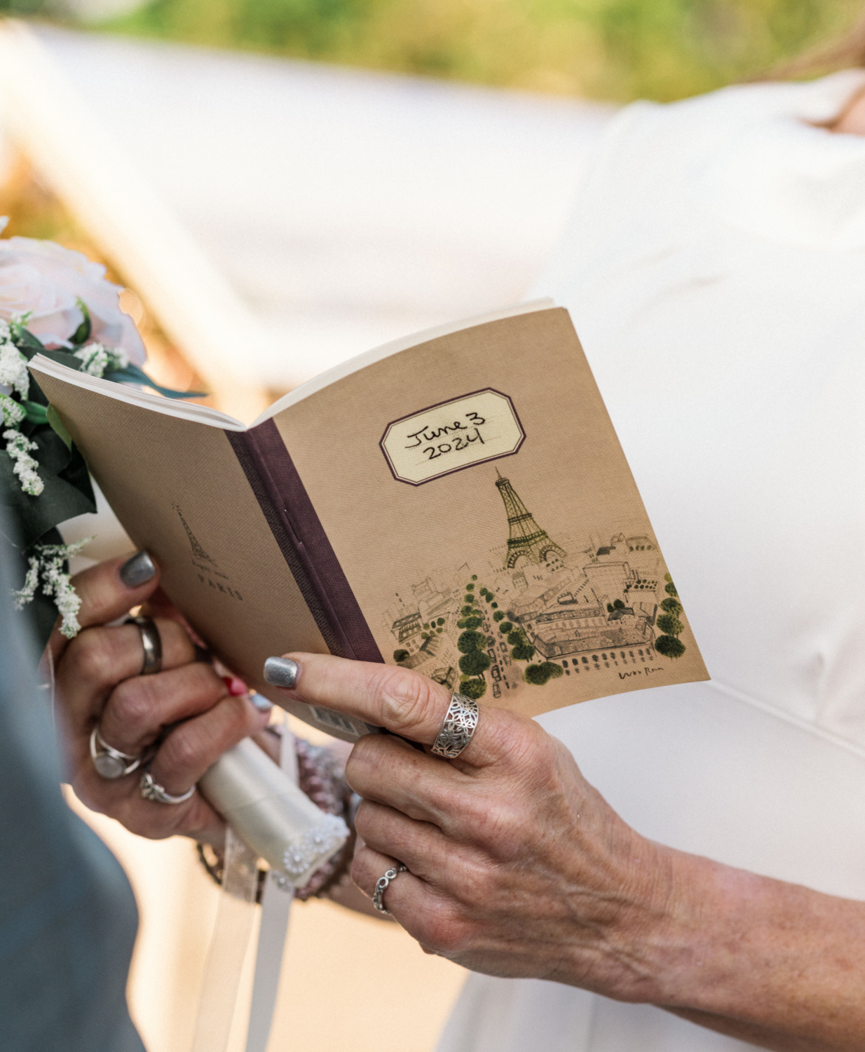 woman holds vow booklet in paris