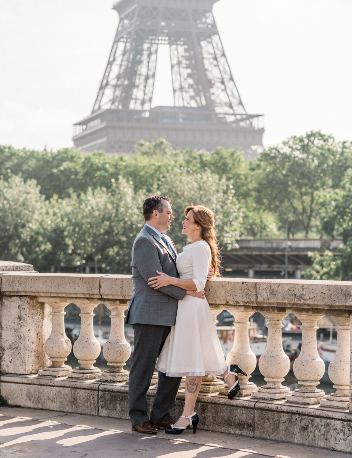 newlyweds embrace with view of eiffel tower