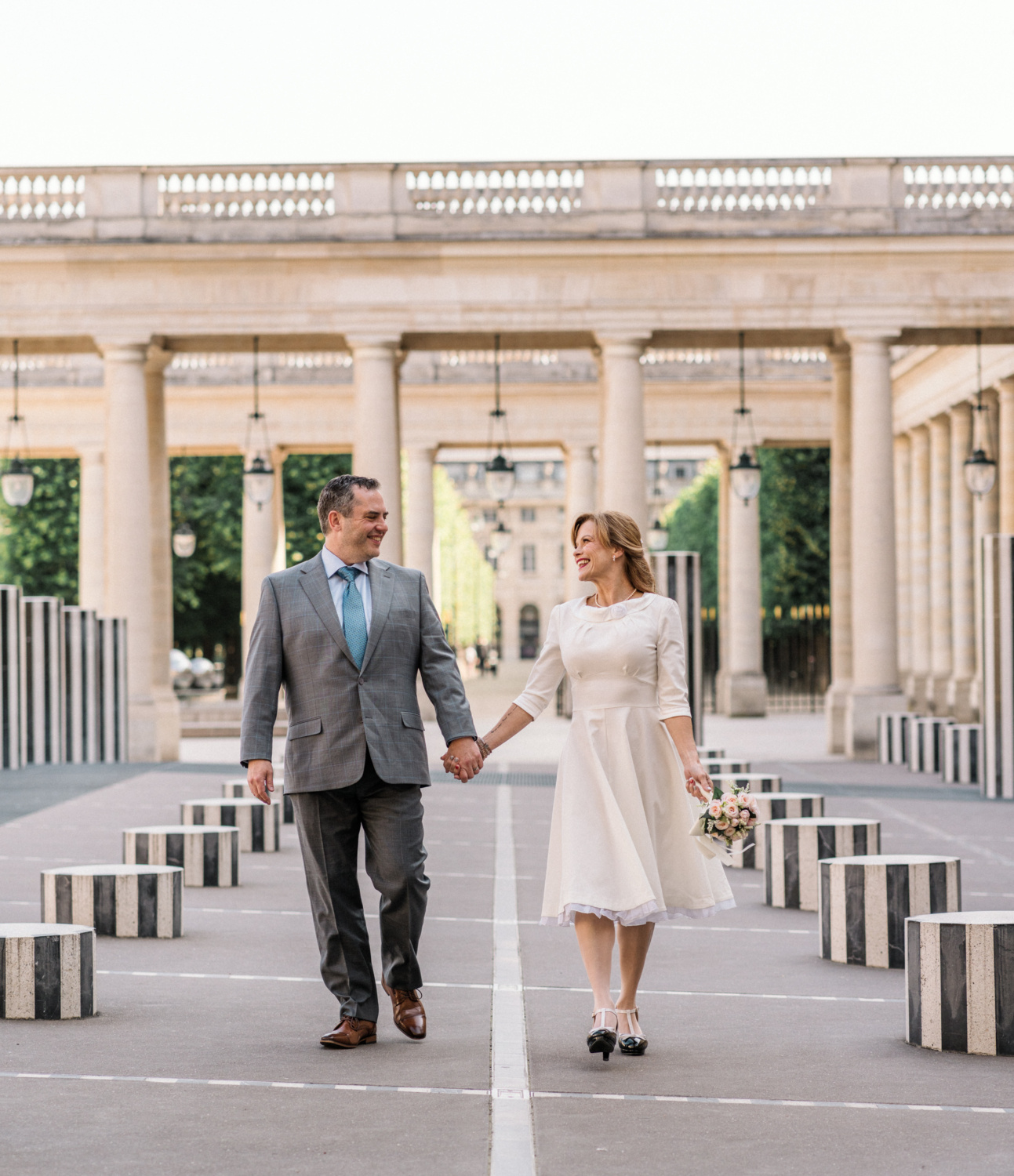 newlyweds walk at the palais royal in paris