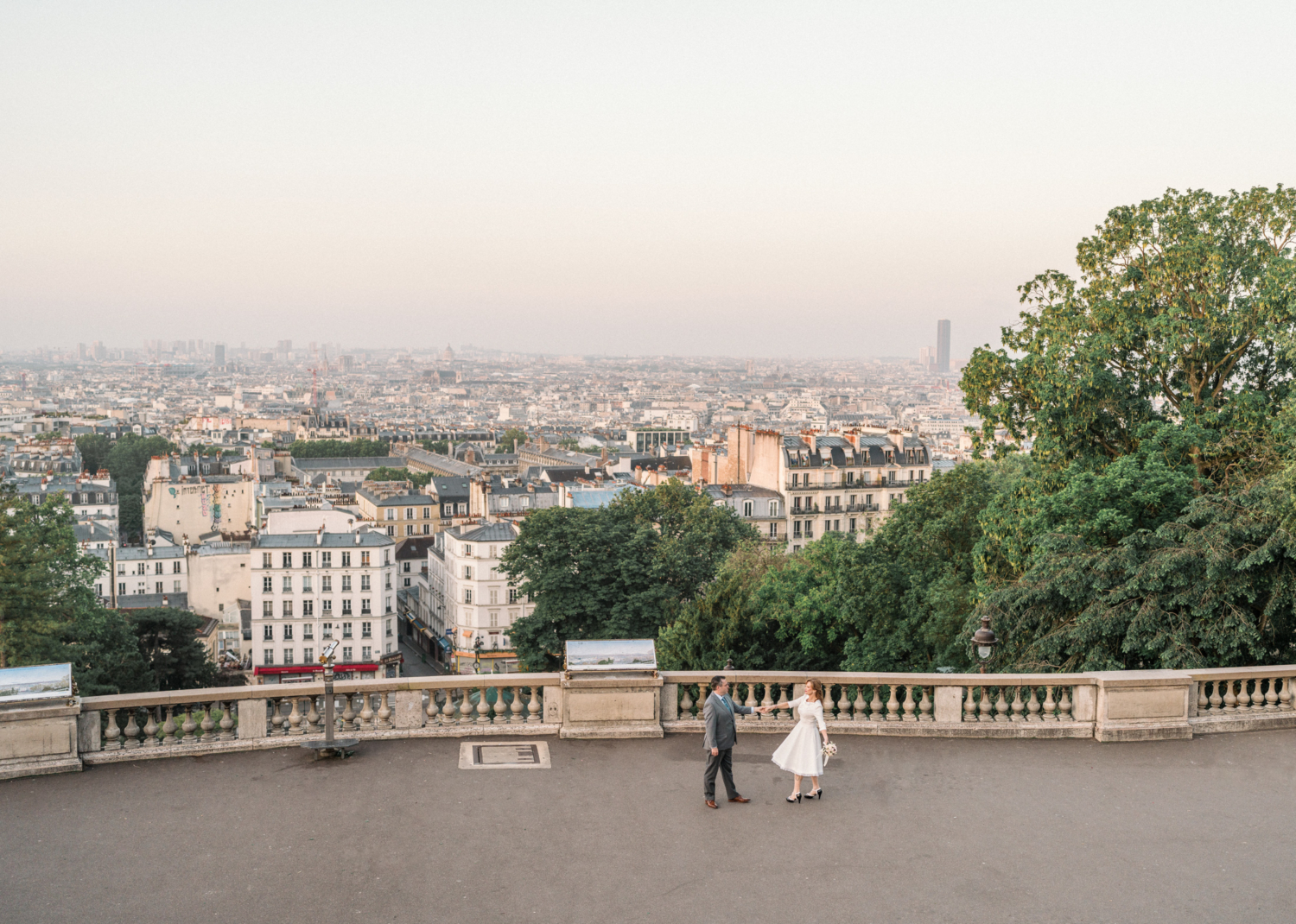 newlyweds dance with view of paris from montmartre