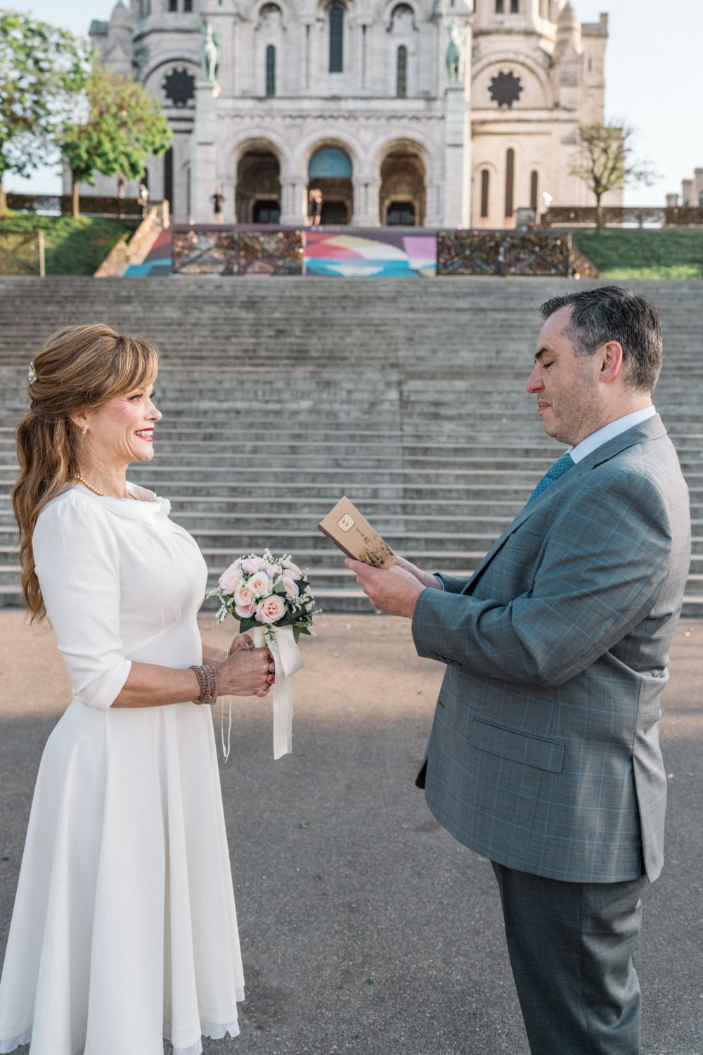 couple say their wedding vows in paris with view of basilica