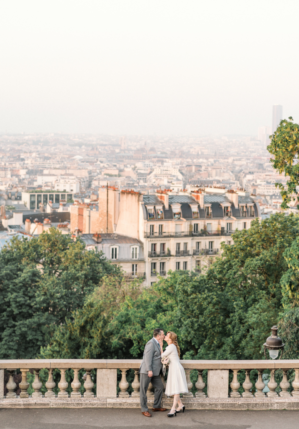 woman kisses man with incredible view in paris