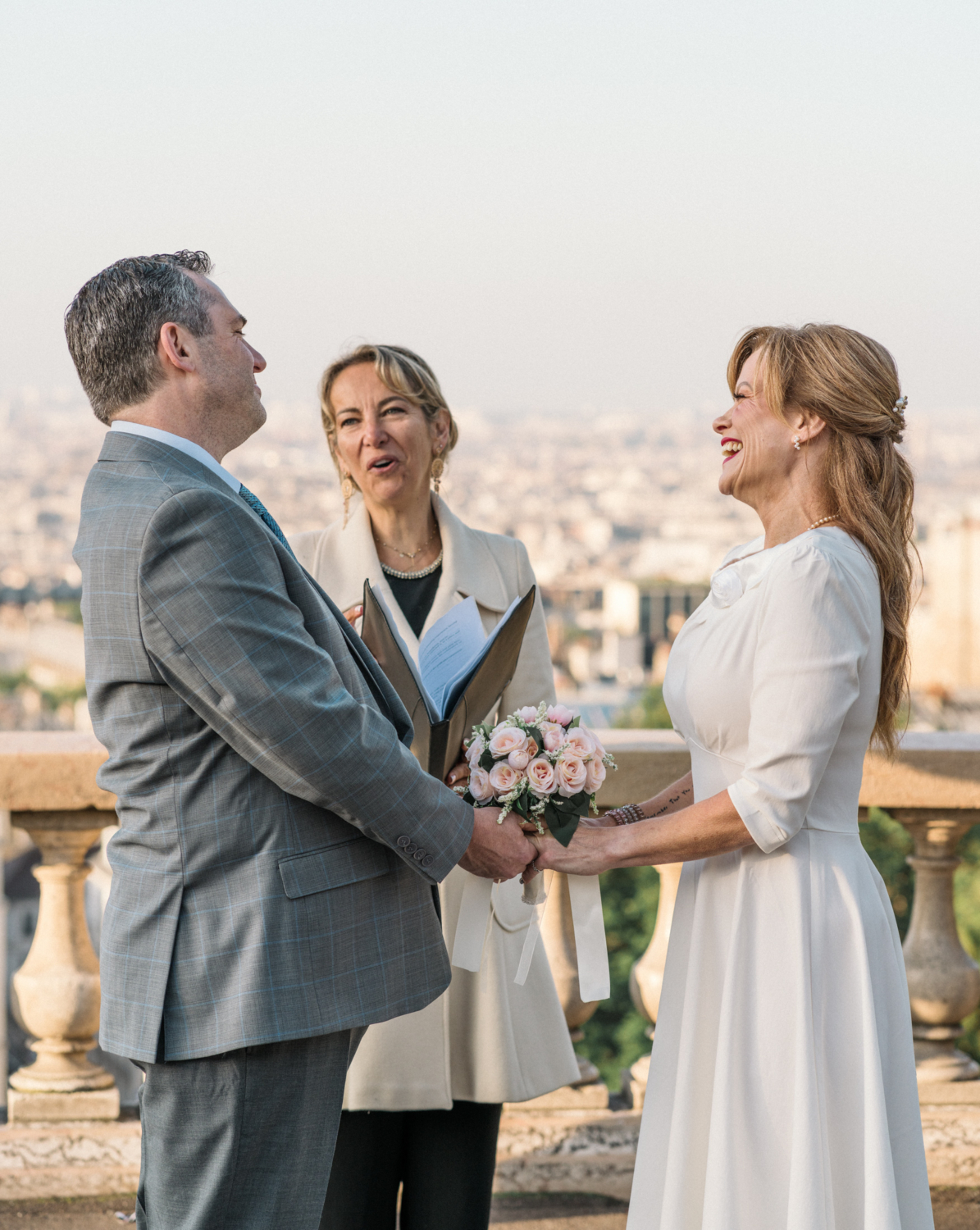 couple laugh during their elopement ceremony in paris