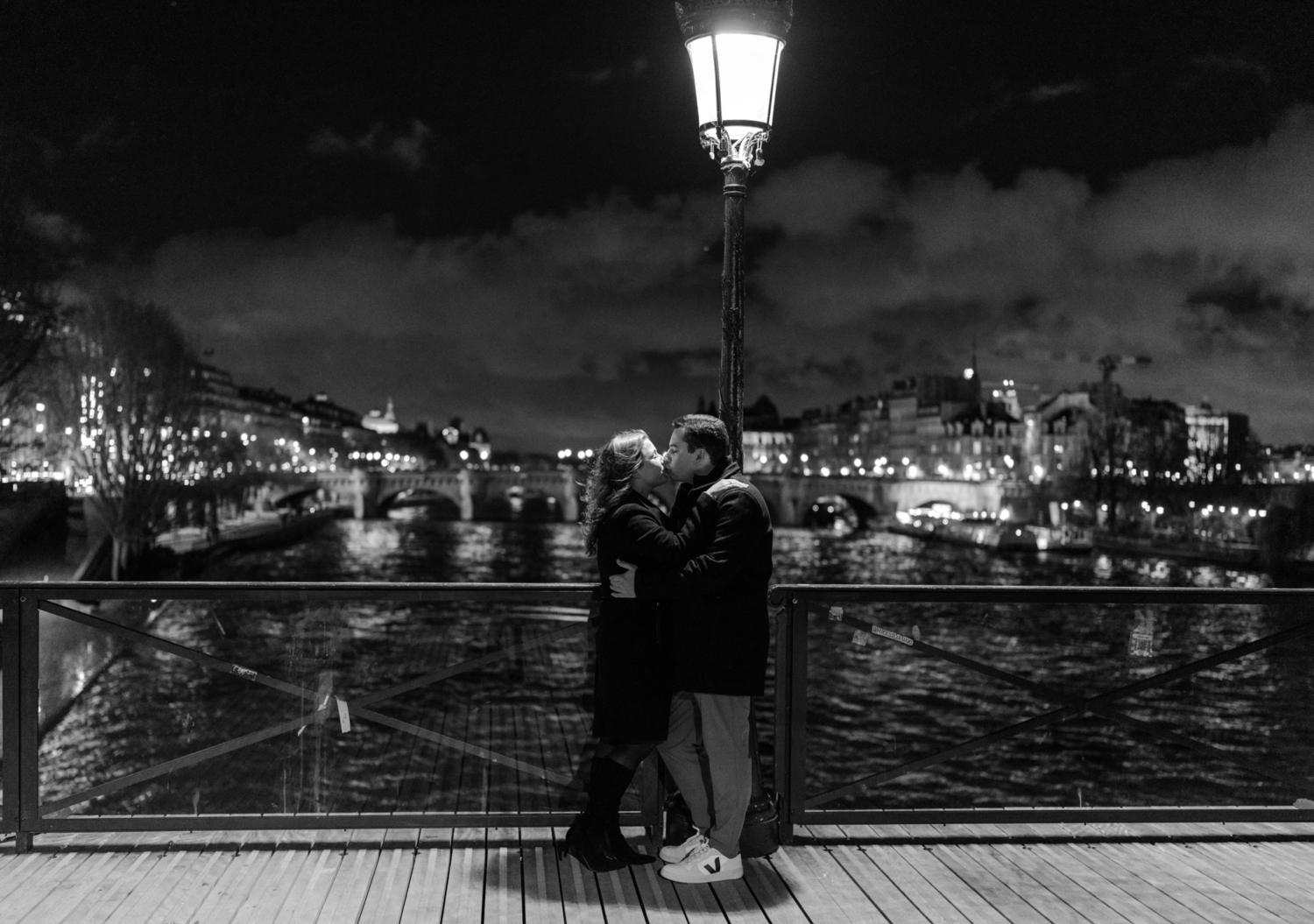 engaged couple kiss passionately in paris at night