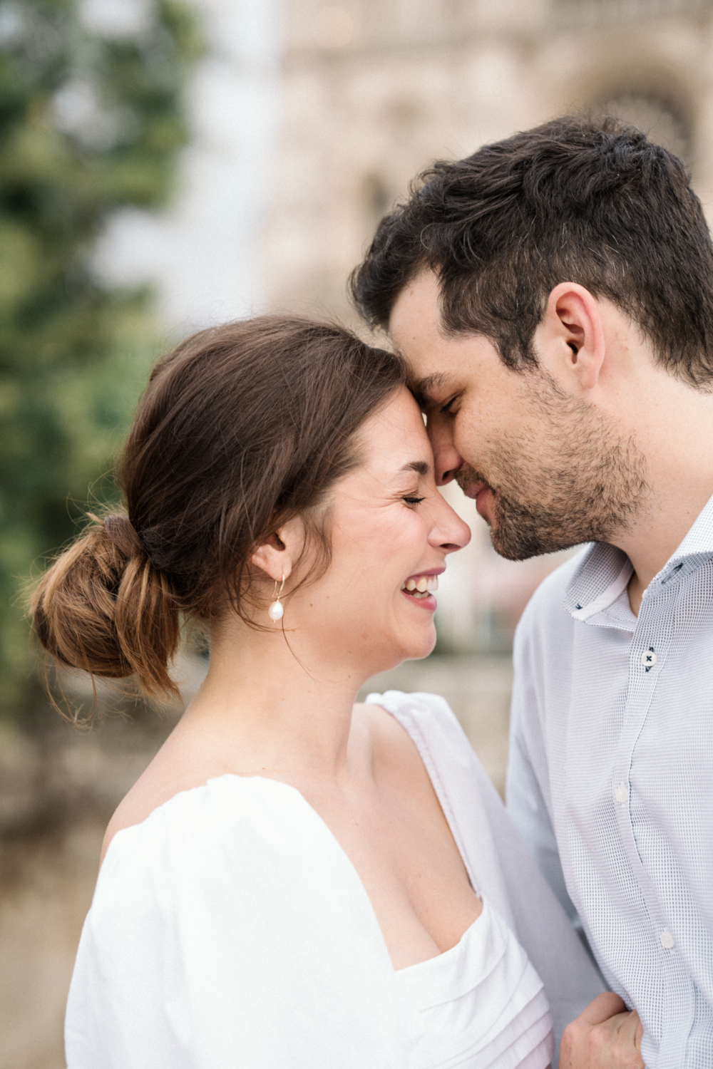 engaged couple smiling during photoshoot in paris