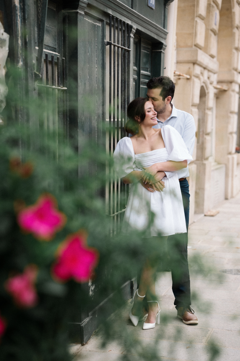 engaged couple embrace in charming paris neighborhood