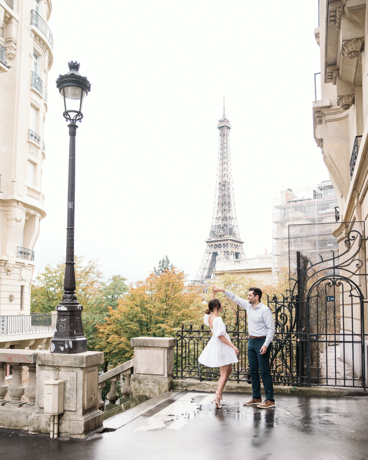 engaged couple dance at the eiffel tower in paris