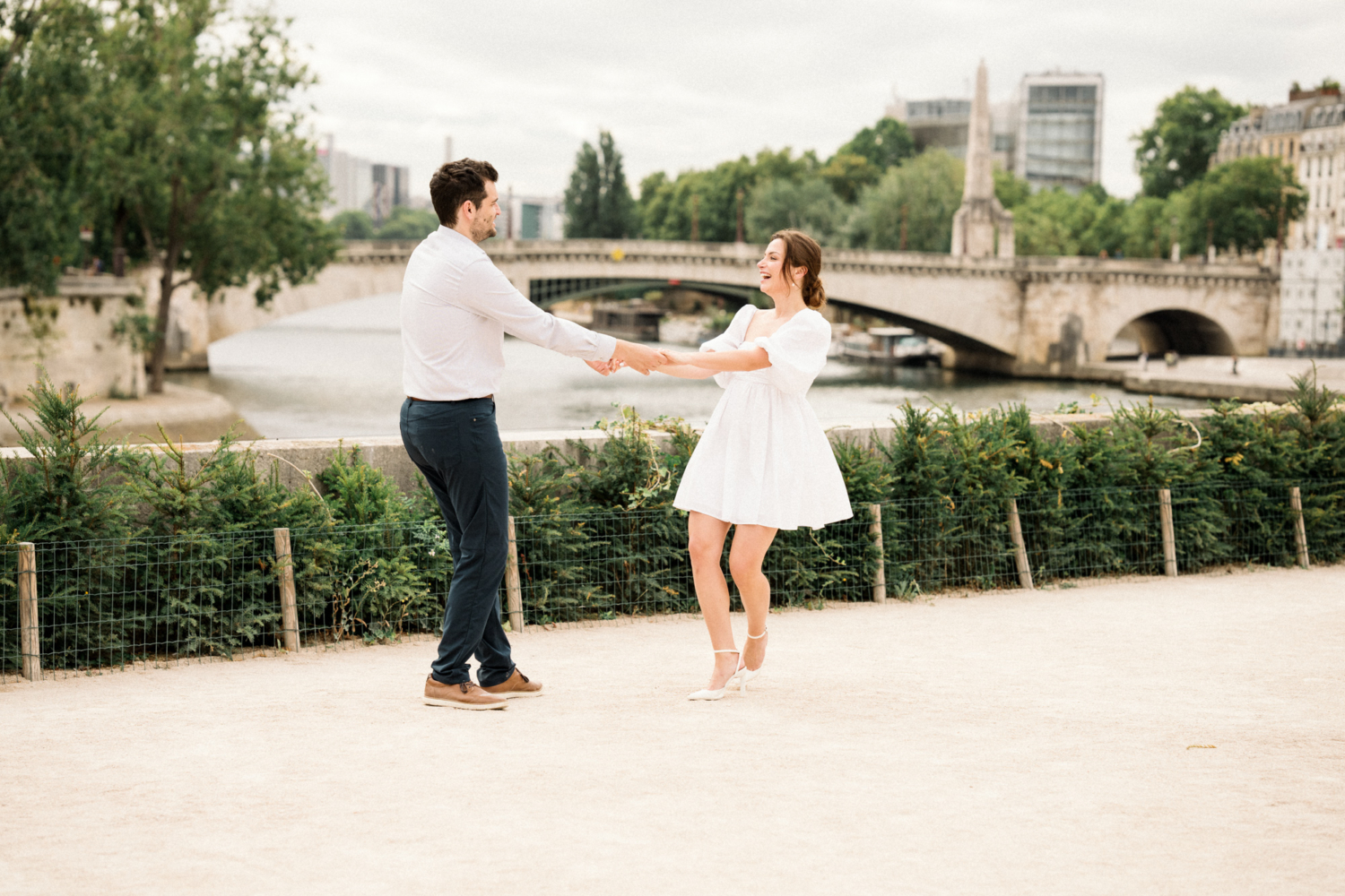 engaged couple twirl in paris