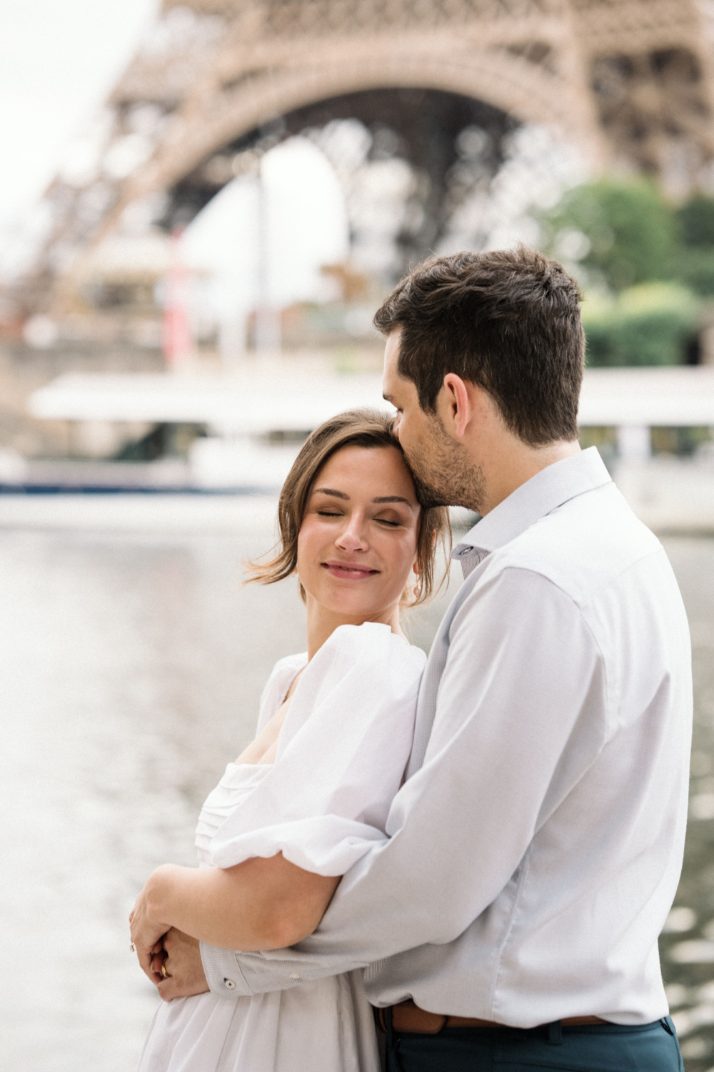 man kisses woman on forehead in paris