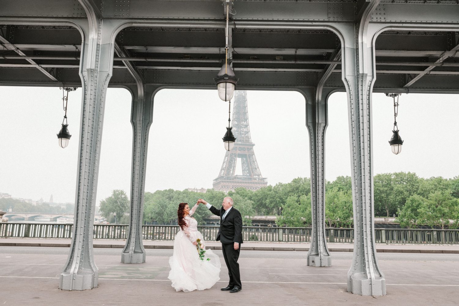 bride and groom dance with view of the eiffel tower