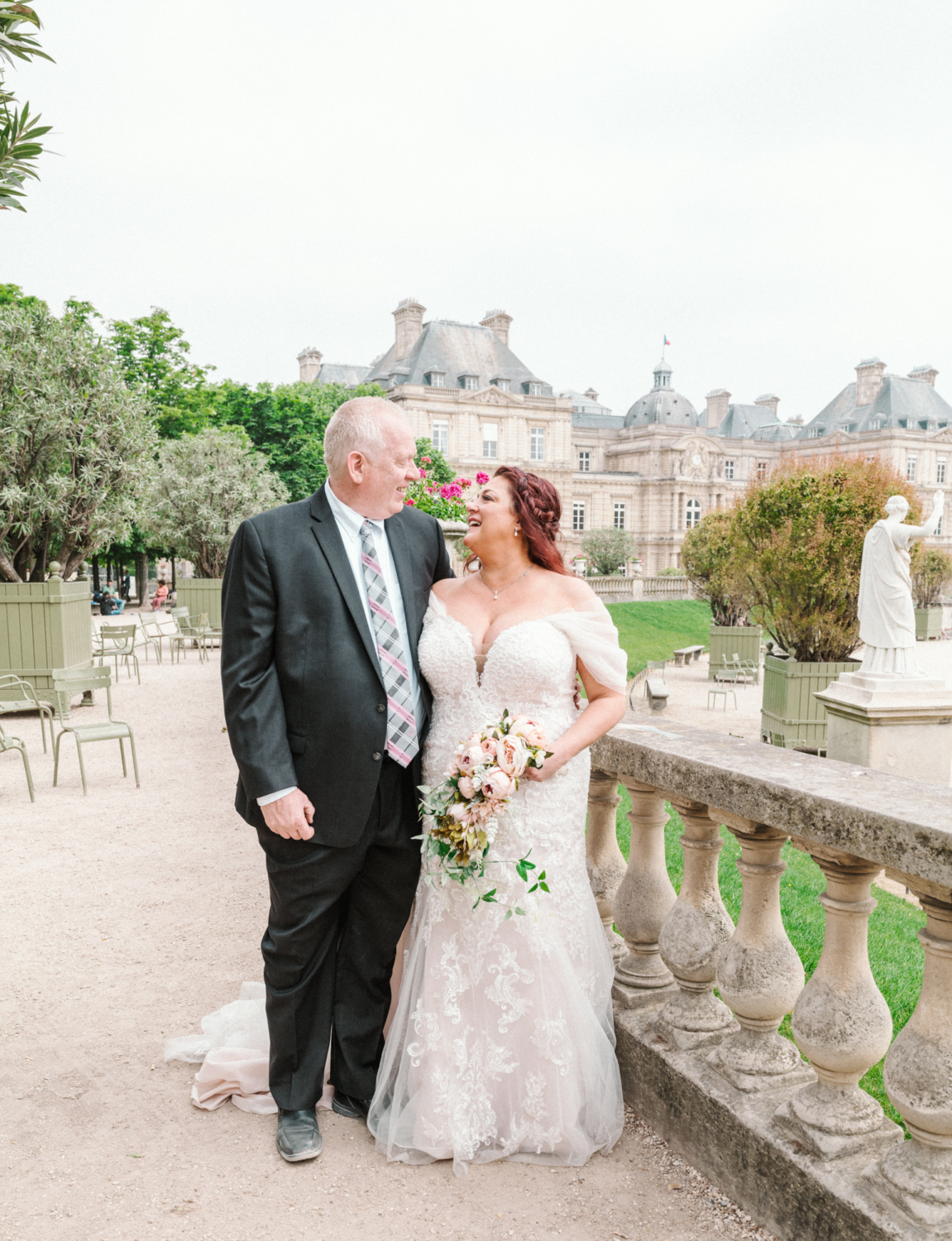 happy bride and groom smile at luxembourg gardens in paris france