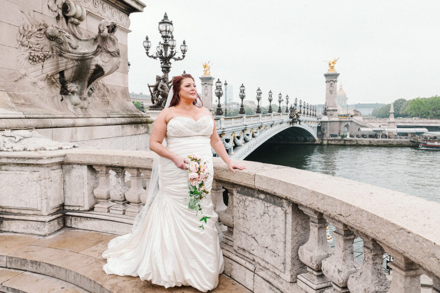 bride poses on bridge of pont alexandre in paris