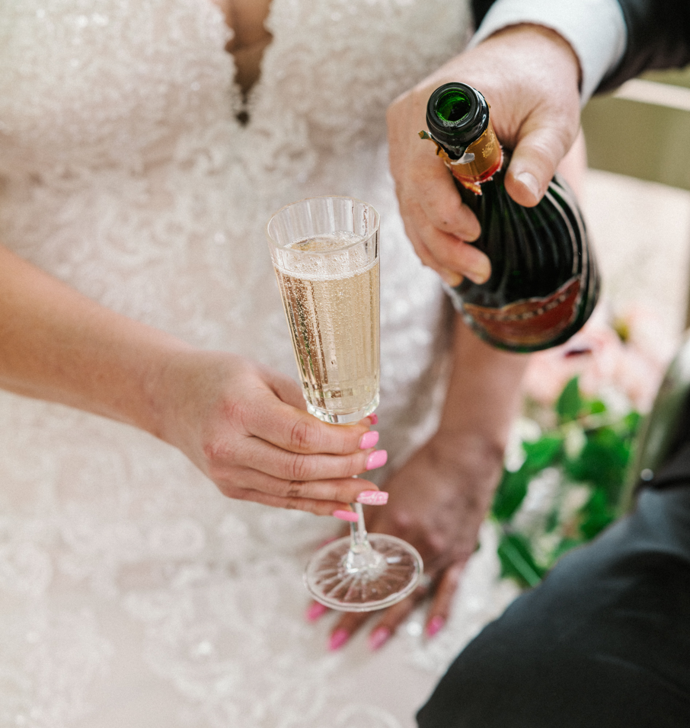 bride and groom share a glass of champagne on their wedding day