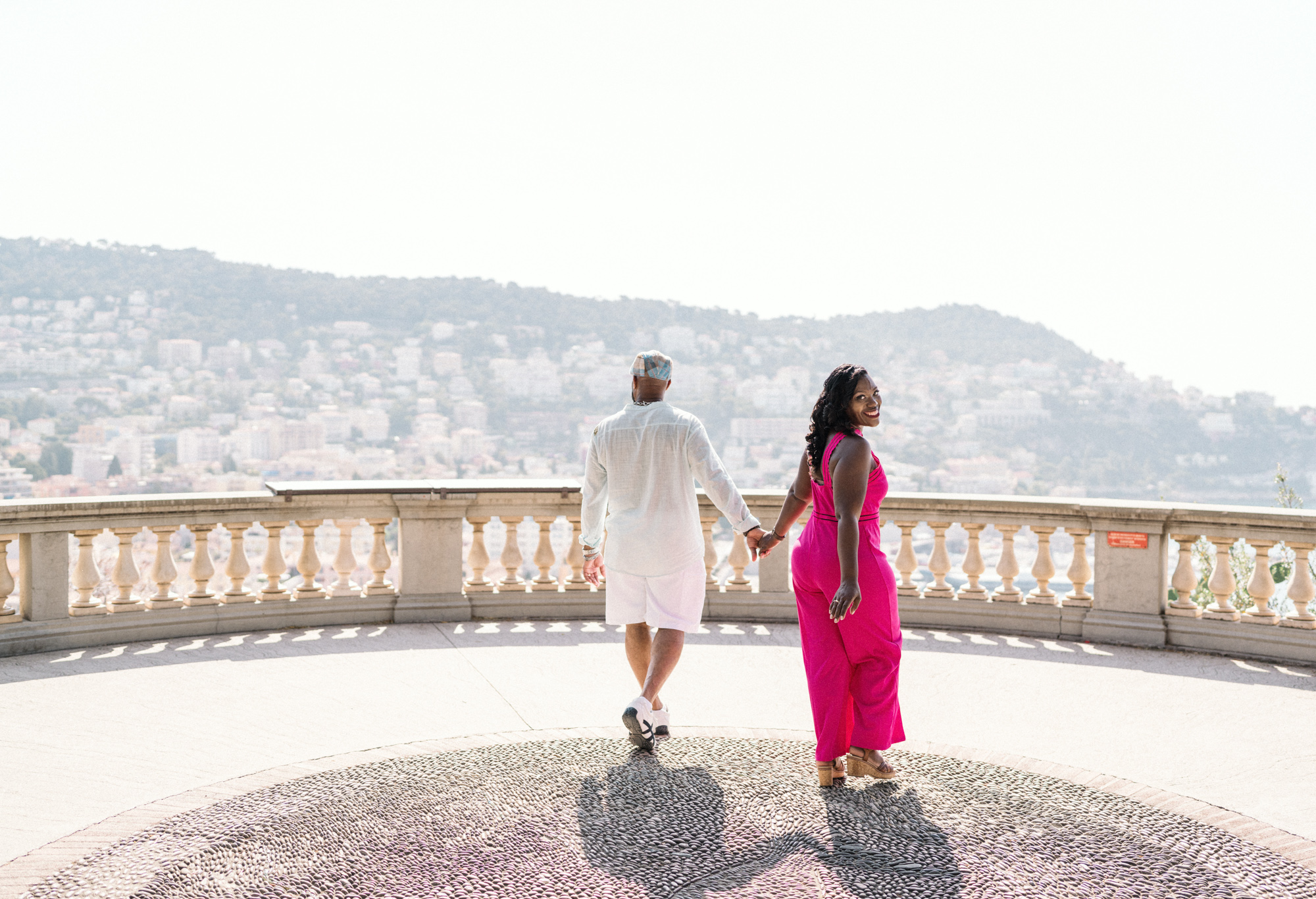woman looks at camera while she walks with man in nice france