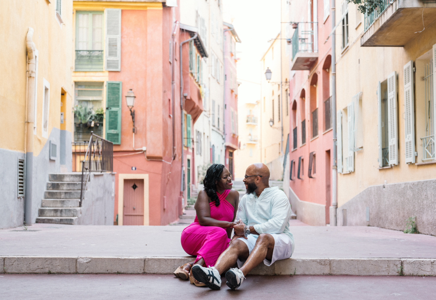 couple share a laugh in colorful neighborhood in nice france