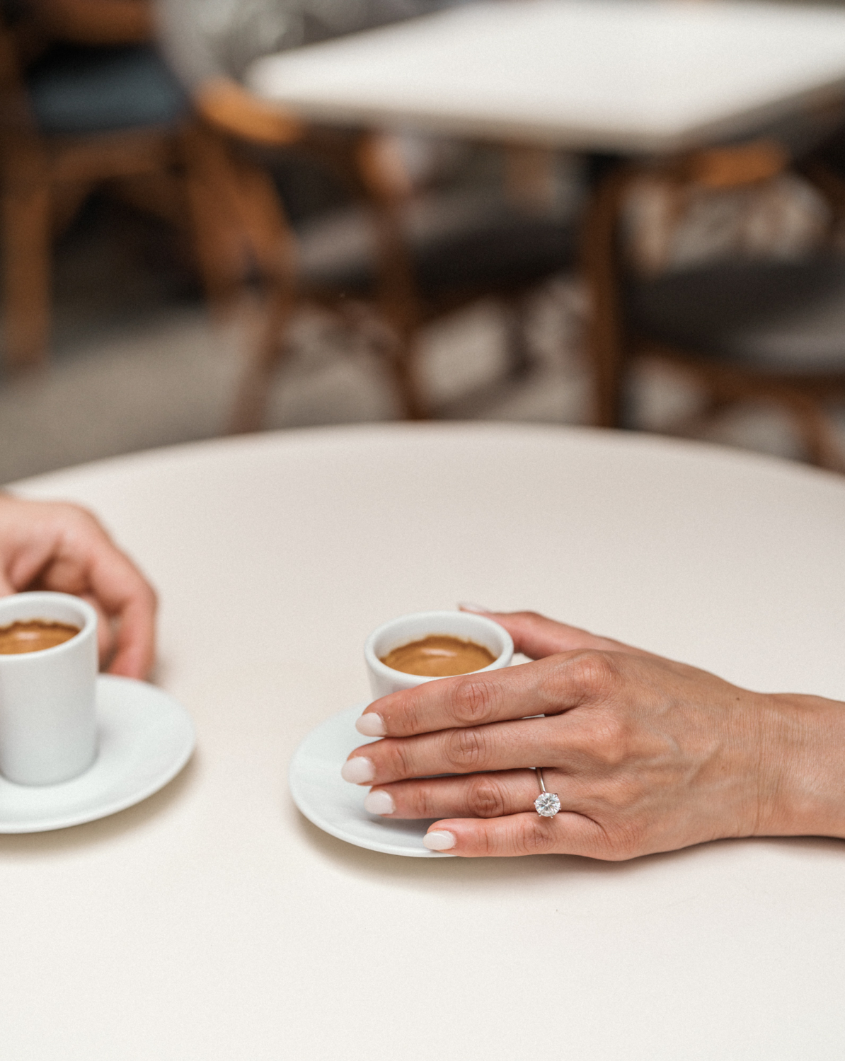 woman hold espresso cup with diamond ring