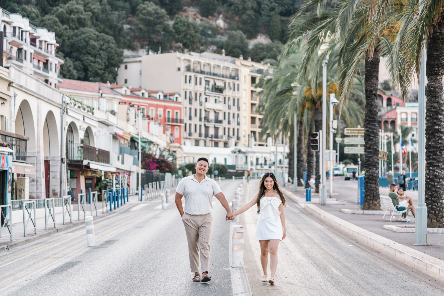 newly married couple walk on the promenade des anglais in nice france