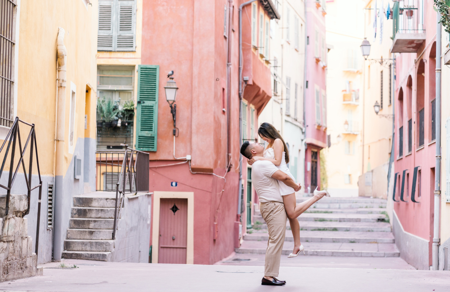 husband lifts wife in the air in old town nice france