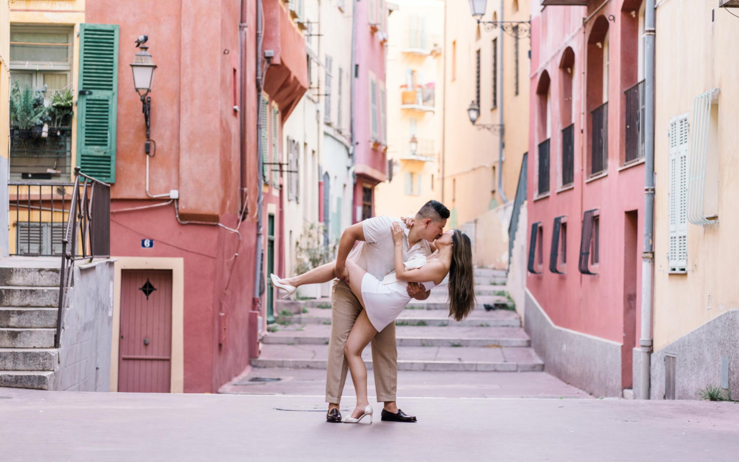 man dips wife backward and kisses her in old town nice france