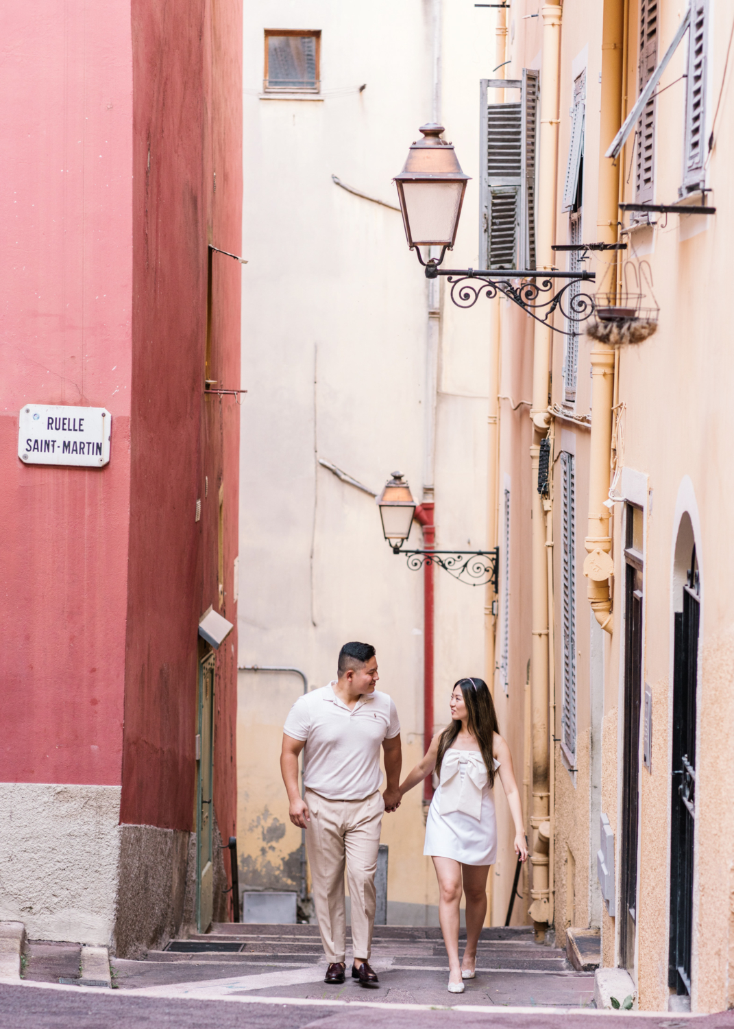 happy couple walk through old town nice france in summer