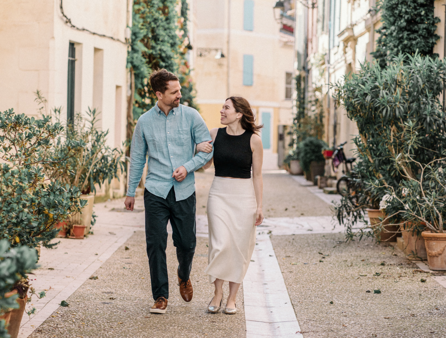 cute couple walk arm in arm in provence