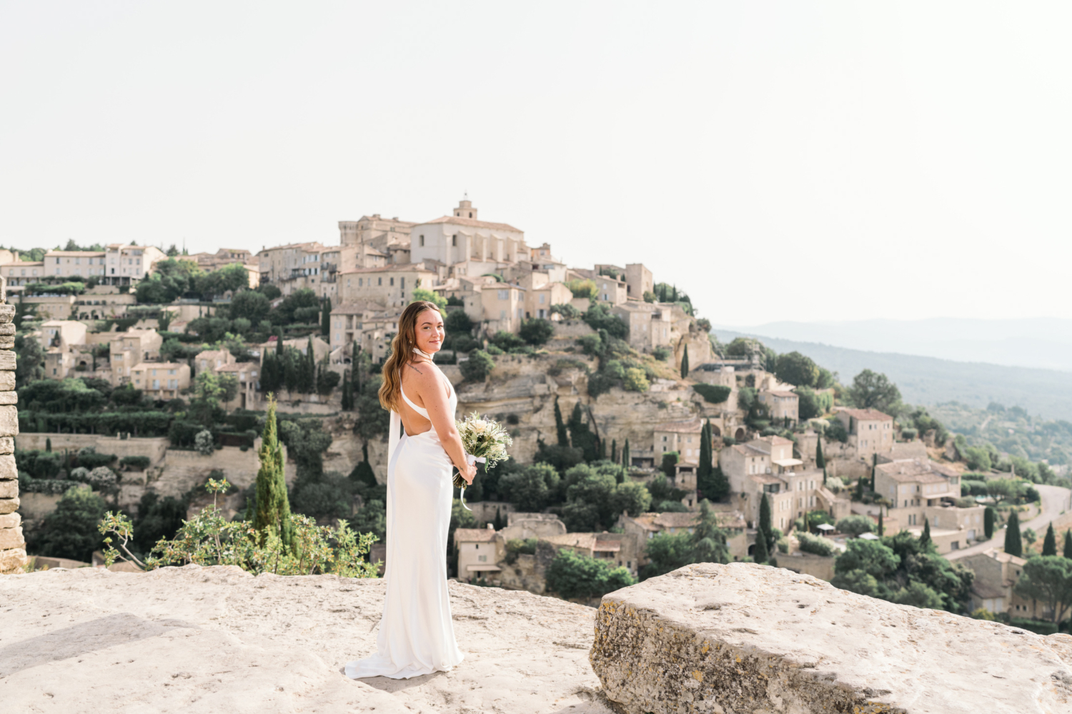 bride smiles with view of gordes france