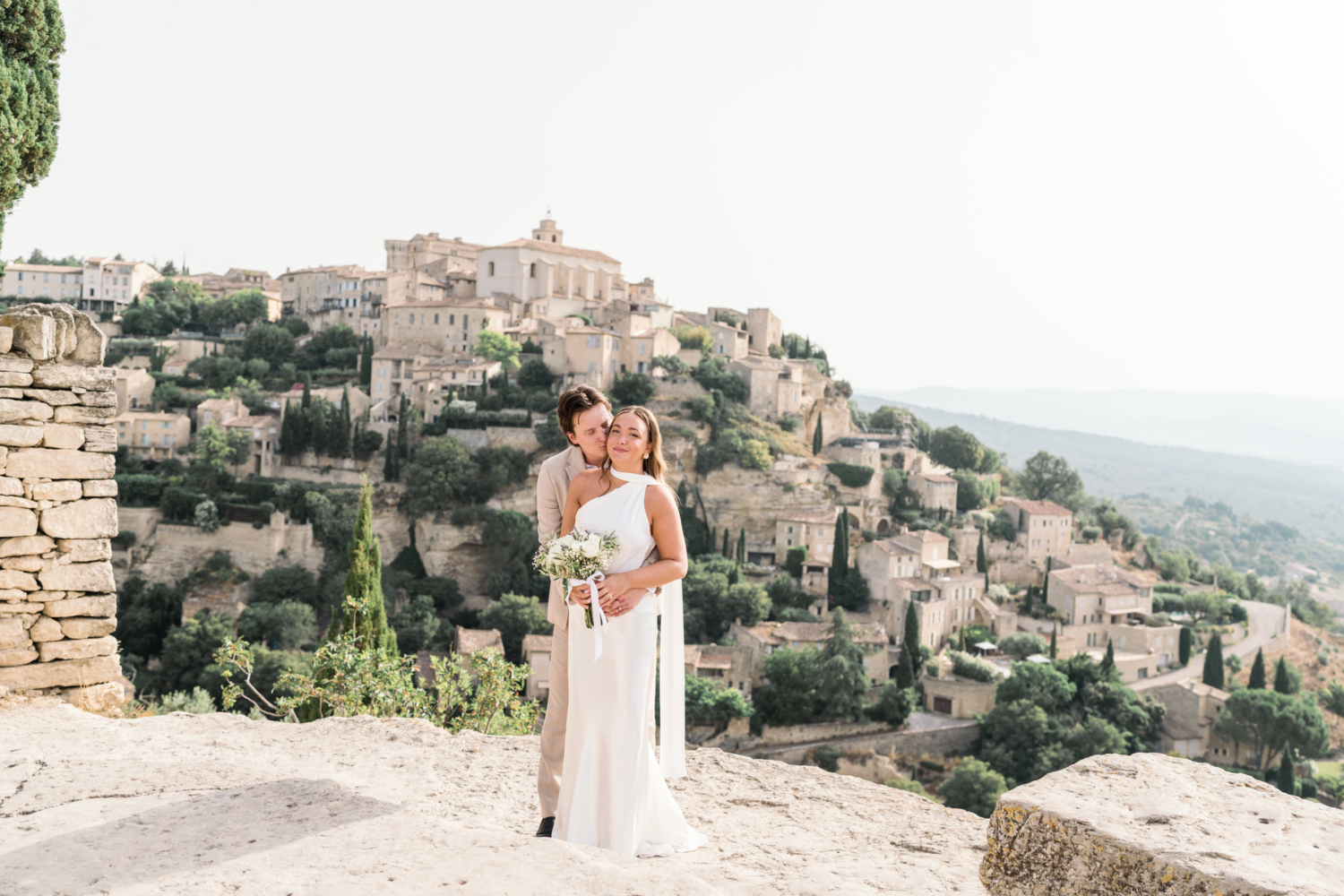 groom kisses bride in gordes france