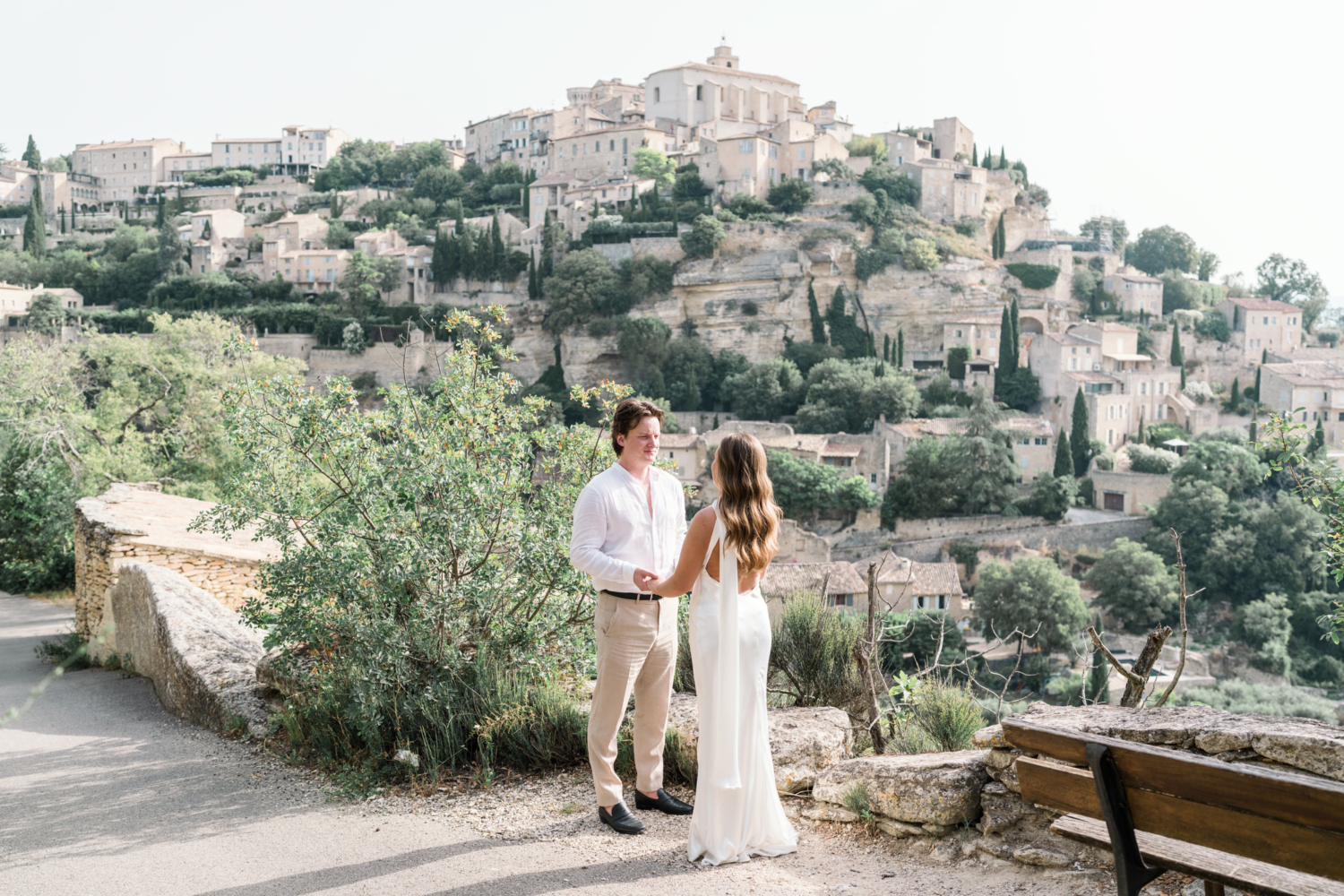 newlyweds hold hands in gordes france