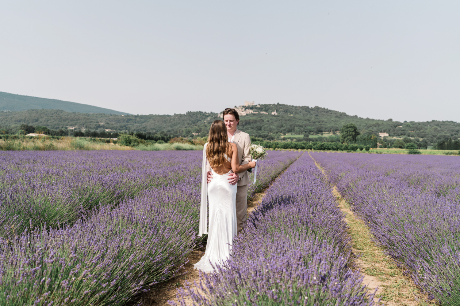 bride and groom hold each other in lavender field in provence france