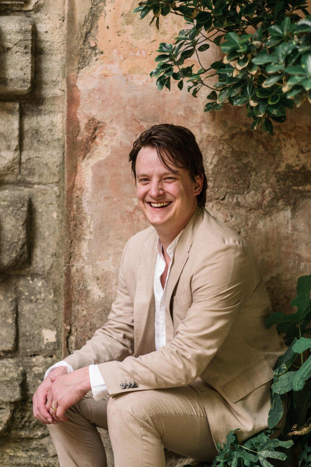 groom laughs on his wedding day in gordes france