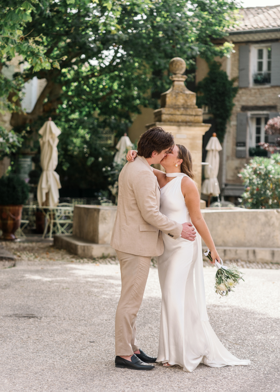 bride and groom kiss in old town in gordes france