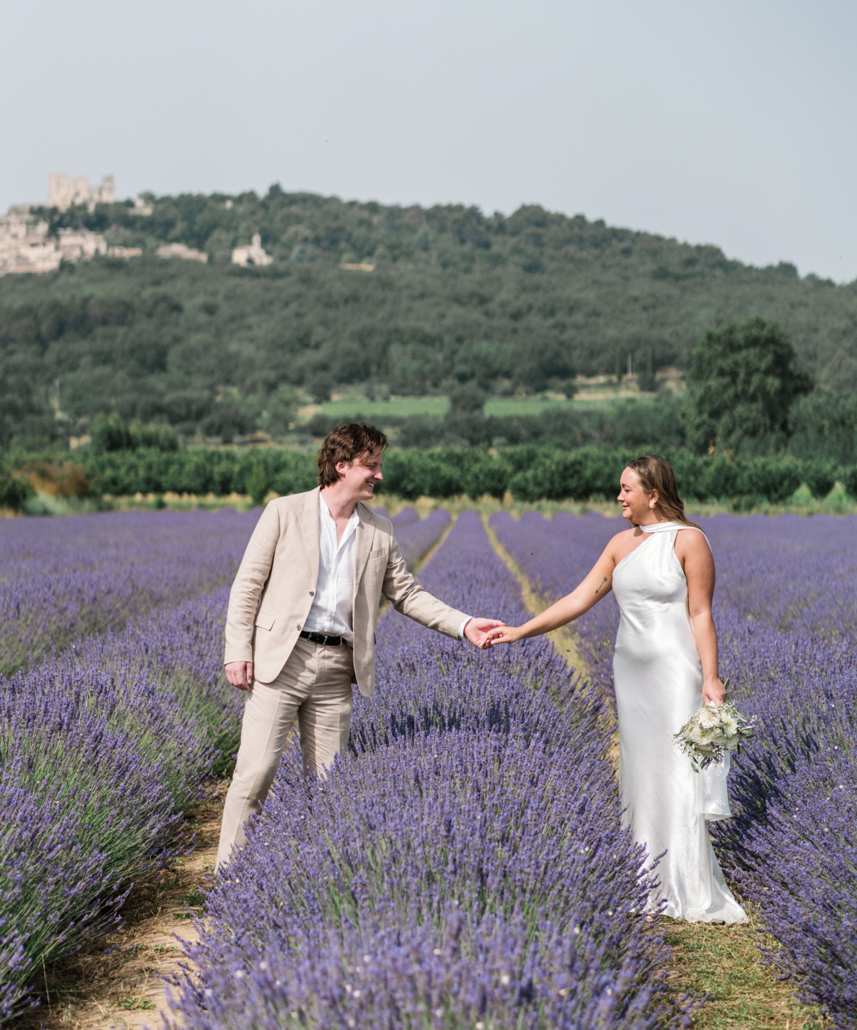 bride and groom pose in the lavender fields of provence france