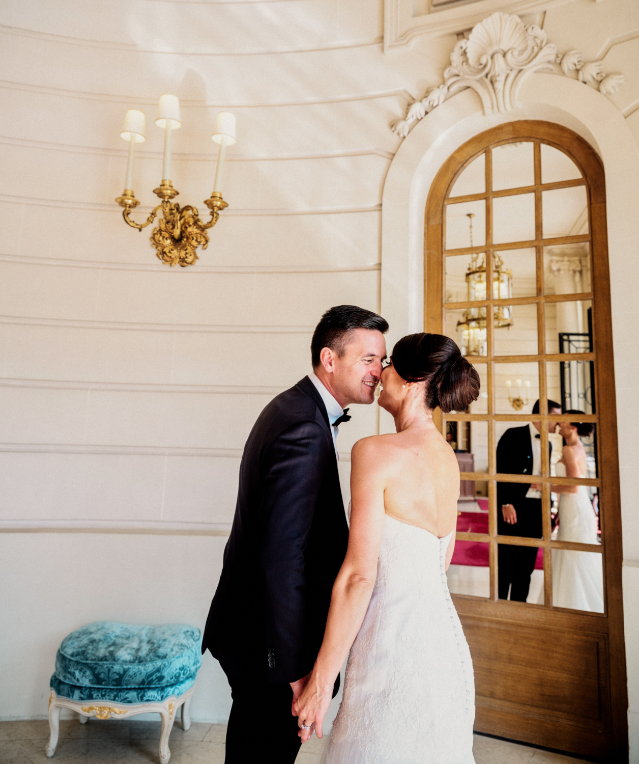 bride and groom laugh in mirror at ritz hotel paris