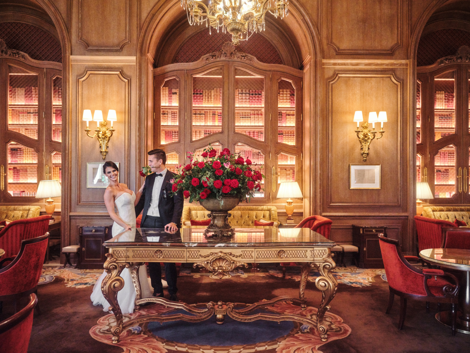 groom holds rose in mouth at ritz hotel paris