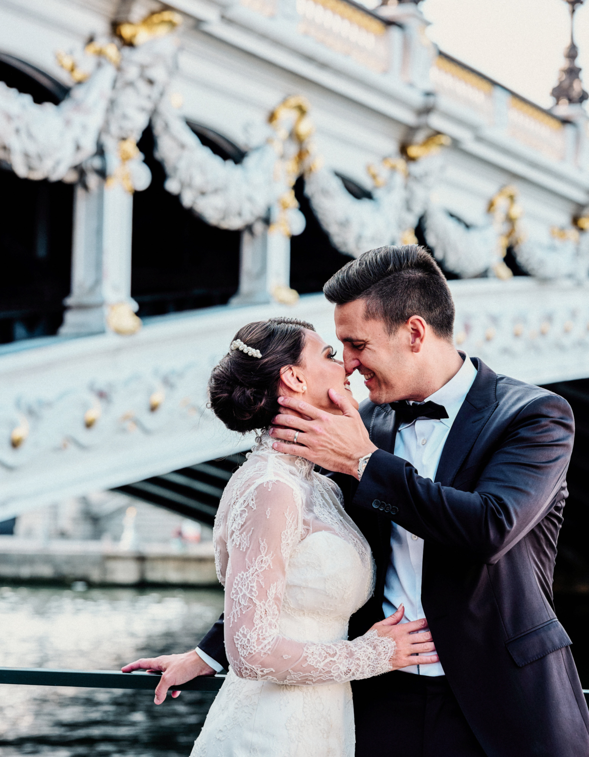 bride and groom touch noses on wedding day in paris