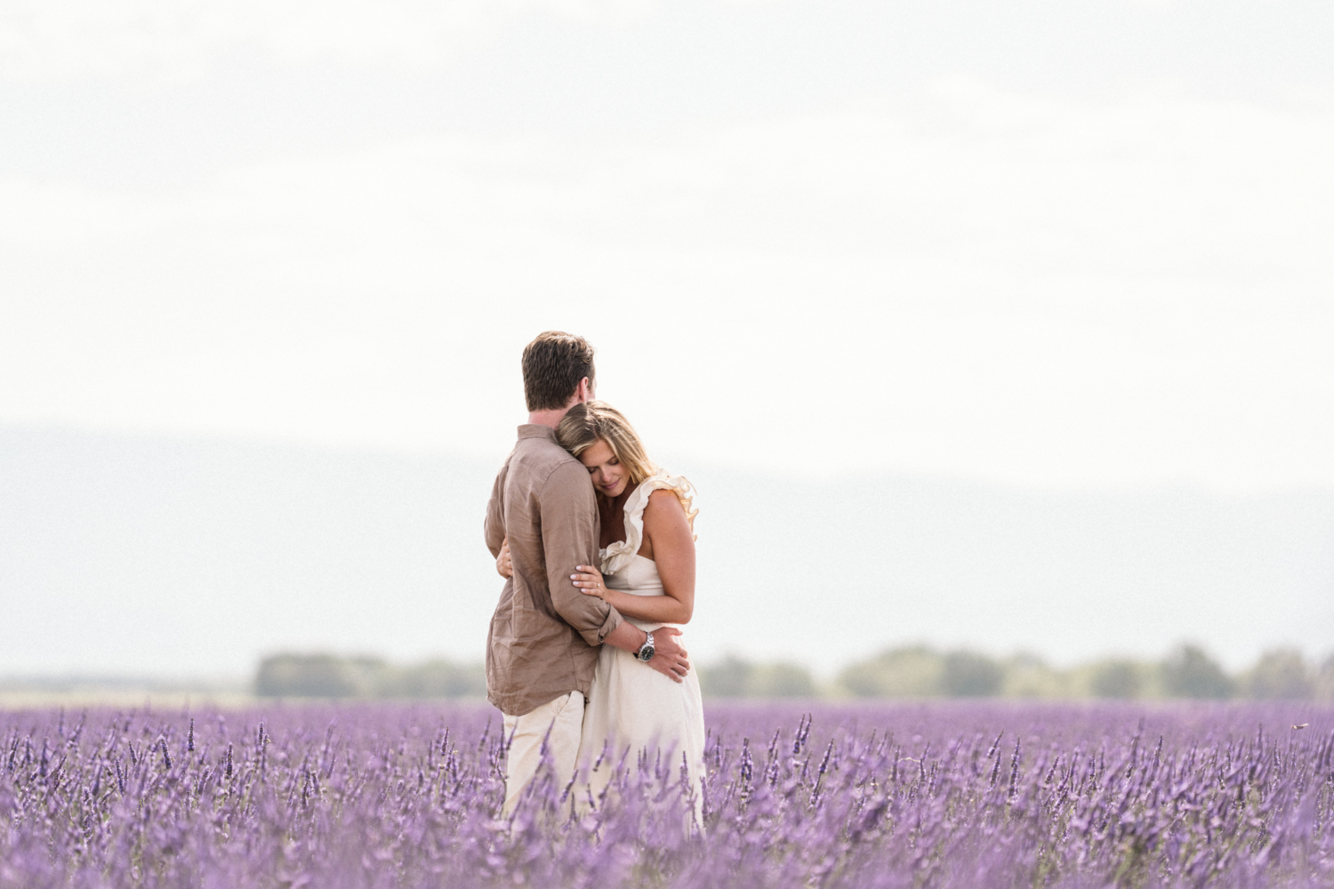woman embraces man in lavender field